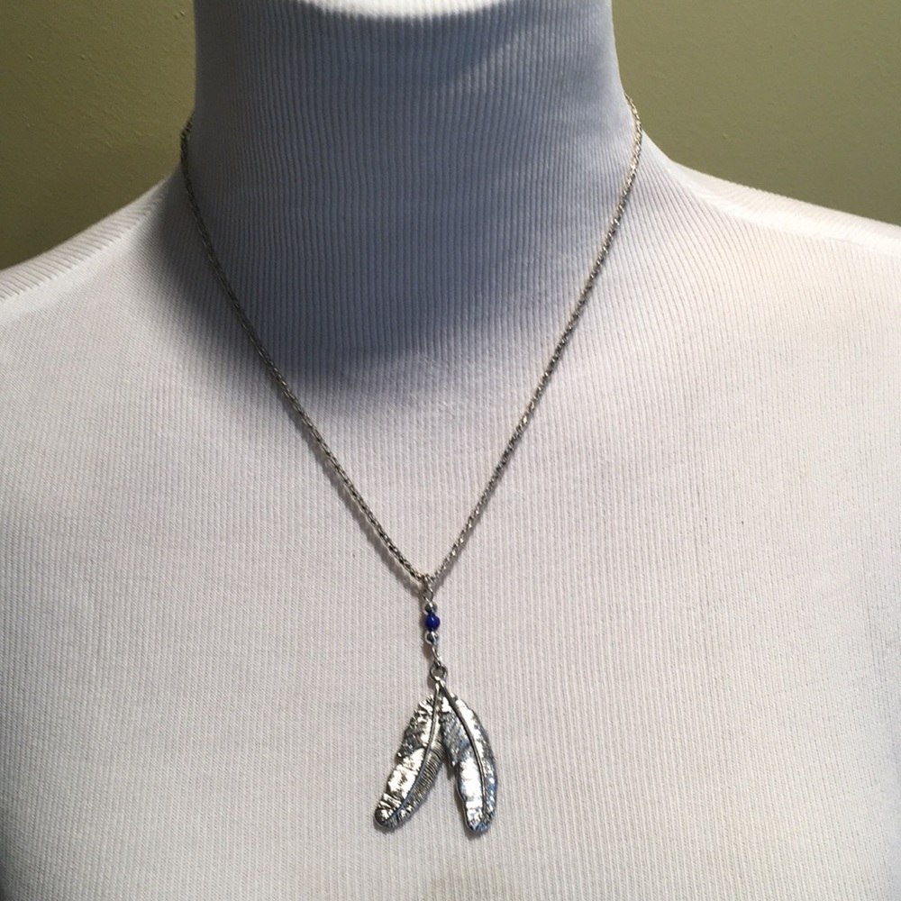 Silver tone necklace with beads and feather